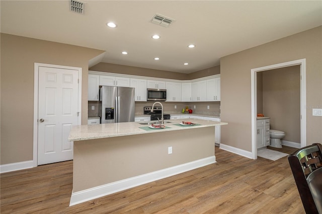 4189 Radford Rd, Bartow, FL 33830 - kitchen featuring appliances with stainless steel finishes, white cabinets, a sink, baseboards, and recessed lighting