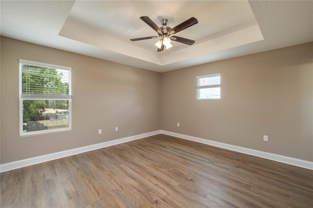4189 Radford Rd, Bartow, FL 33830 - empty room featuring a raised ceiling, wood finished floors, baseboards, and ceiling fan