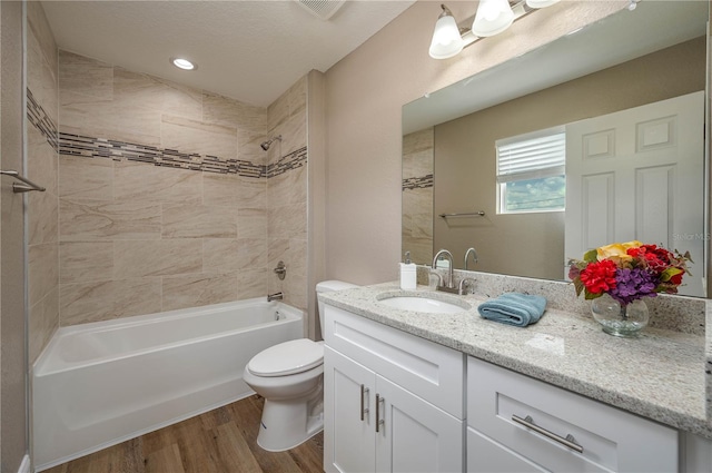 4189 Radford Rd, Bartow, FL 33830 - bathroom with vanity, toilet, wood finished floors, and bathing tub / shower combination