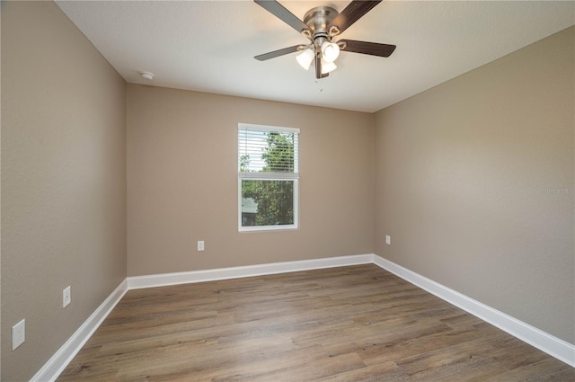 4189 Radford Rd, Bartow, FL 33830 - empty room with a ceiling fan, wood finished floors, a smoke detector, and baseboards