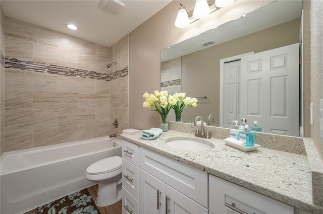 4189 Radford Rd, Bartow, FL 33830 - bathroom with vanity, toilet,  shower combination, wood finished floors, and recessed lighting