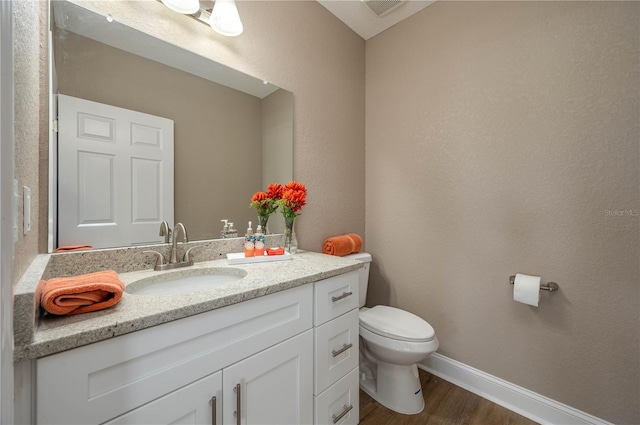 4189 Radford Rd, Bartow, FL 33830 - bathroom with toilet, vanity, and wood finished floors