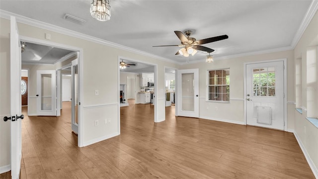 interior space featuring visible vents, baseboards, ornamental molding, ceiling fan, and light wood-style floors