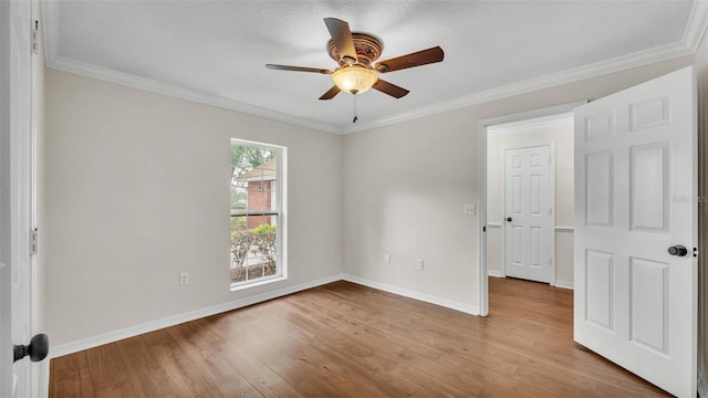 unfurnished room featuring wood finished floors, ceiling fan, and ornamental molding