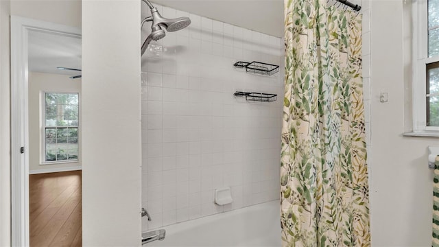 full bath with wood finished floors and shower / bath combo with shower curtain