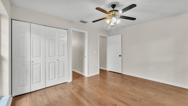 unfurnished bedroom with visible vents, baseboards, a closet, ceiling fan, and light wood finished floors