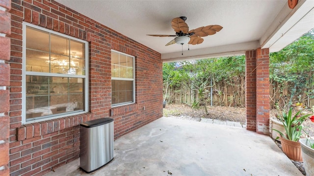 view of patio with a ceiling fan and fence