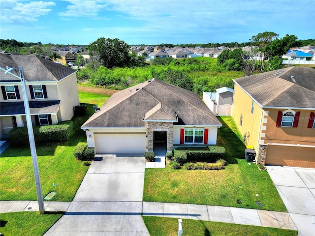 view of front of house featuring a front yard, a garage, stucco siding, a residential view, and driveway