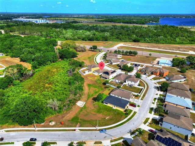 aerial view with a water view, a residential view, and a forest view