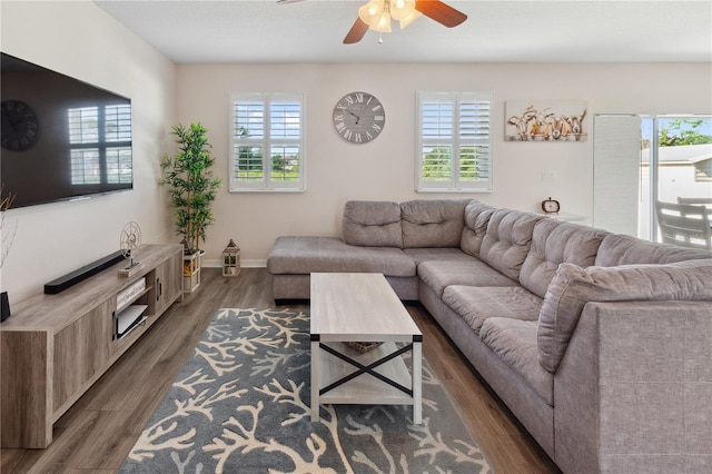 living room with plenty of natural light, baseboards, wood finished floors, and ceiling fan