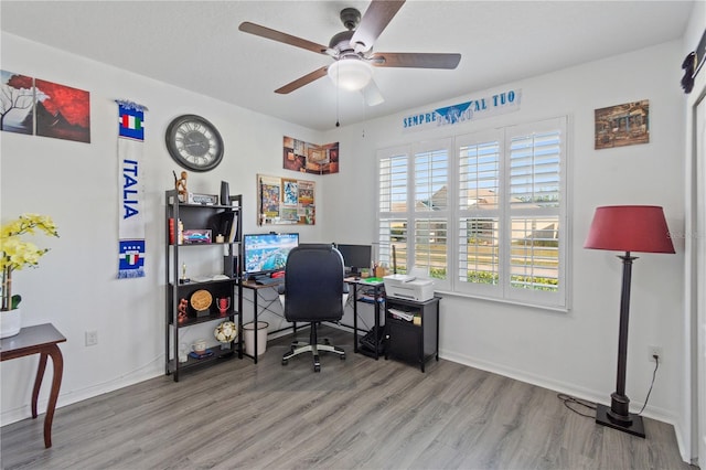 office space with baseboards, a ceiling fan, and wood finished floors