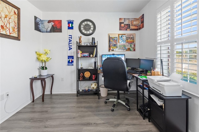 office area with baseboards and wood finished floors