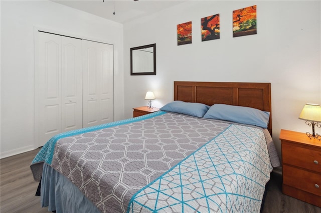 bedroom with a closet, baseboards, and wood finished floors