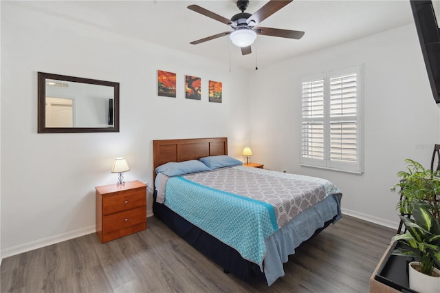bedroom with wood finished floors, ceiling fan, and baseboards