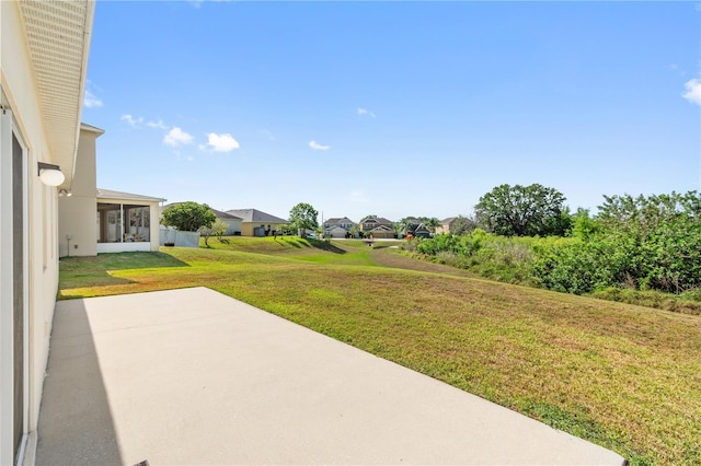 view of yard featuring a patio area and a residential view