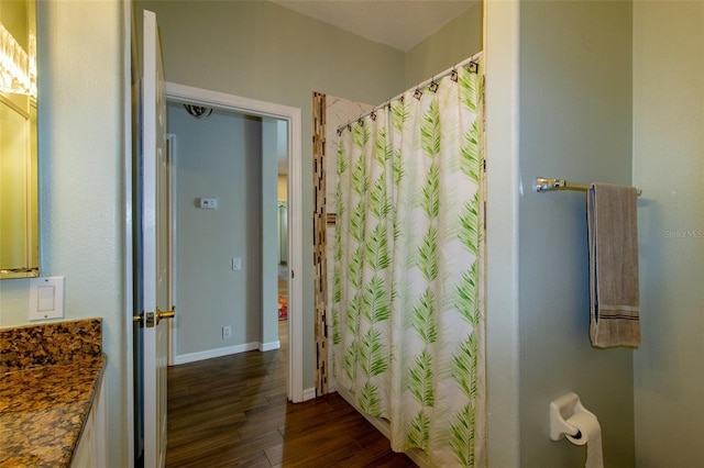 6626 Royal Forest Dr, Lakeland, FL 33811 - full bathroom featuring baseboards, curtained shower, and wood finished floors