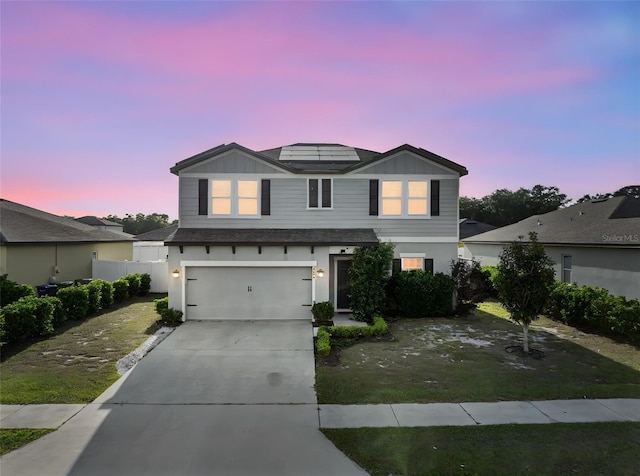 4886 St James Ln, Winter Haven, FL 33881 - traditional-style home featuring a garage, driveway, and roof mounted solar panels