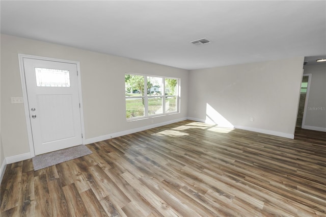 entryway featuring wood finished floors, baseboards, and visible vents