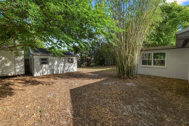 view of yard with an outdoor structure and a storage unit