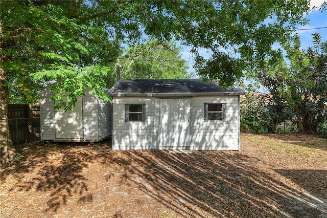 view of shed with fence