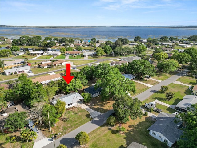 drone / aerial view featuring a residential view and a water view