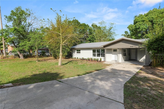 ranch-style house with a carport, a front yard, and driveway