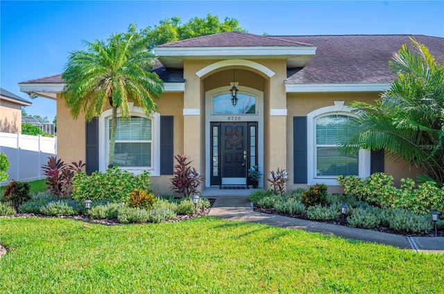 6720 Highlands Creek Loop, Lakeland, FL 33813 - doorway to property with stucco siding and roof with shingles