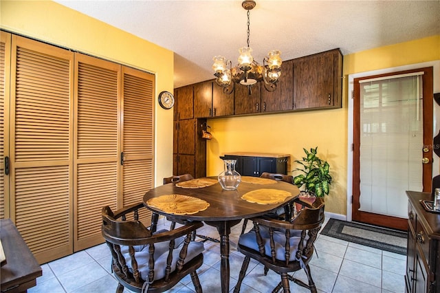4101 N Forbes Rd, Plant City, FL 33565 - dining space with a chandelier, light tile patterned flooring, baseboards, and a textured ceiling