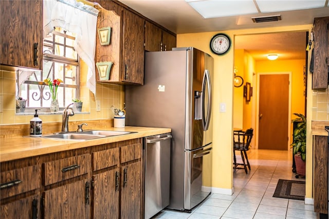 4101 N Forbes Rd, Plant City, FL 33565 - kitchen with a sink, stainless steel dishwasher, tasteful backsplash, and light tile patterned flooring