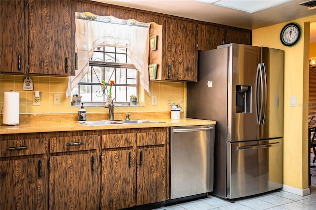 4101 N Forbes Rd, Plant City, FL 33565 - kitchen featuring stainless steel appliances, a sink, decorative backsplash, and light tile patterned floors