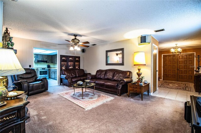 4101 N Forbes Rd, Plant City, FL 33565 - living area featuring carpet floors, a chandelier, ceiling fan, a textured ceiling, and tile patterned flooring