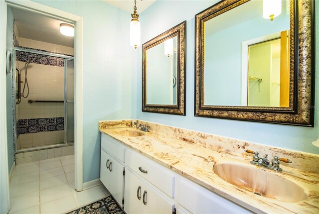 4101 N Forbes Rd, Plant City, FL 33565 - bathroom with a stall shower, tile patterned floors, double vanity, and baseboards