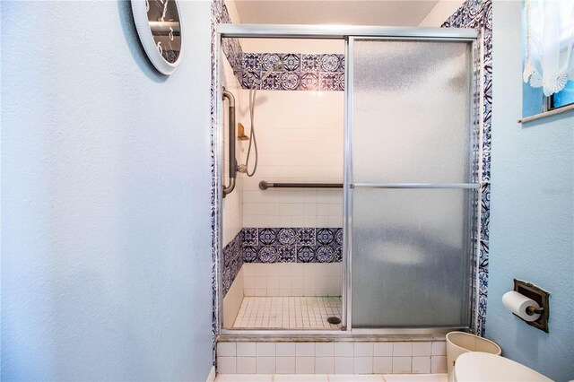 4101 N Forbes Rd, Plant City, FL 33565 - bathroom with toilet, a shower stall, and a textured wall