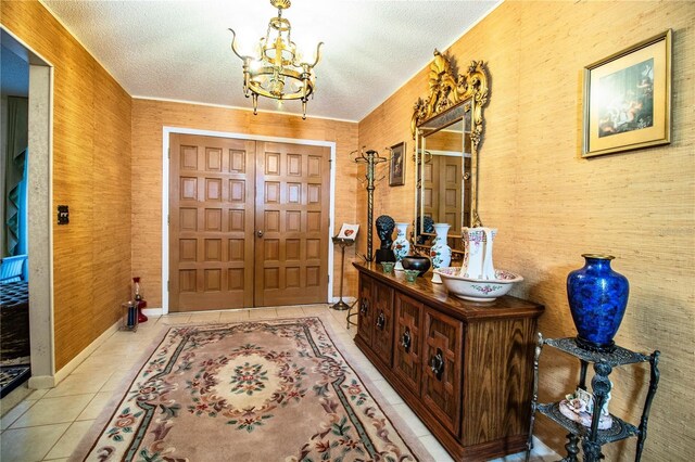 4101 N Forbes Rd, Plant City, FL 33565 - entryway featuring a textured ceiling, a chandelier, tile patterned floors, and baseboards