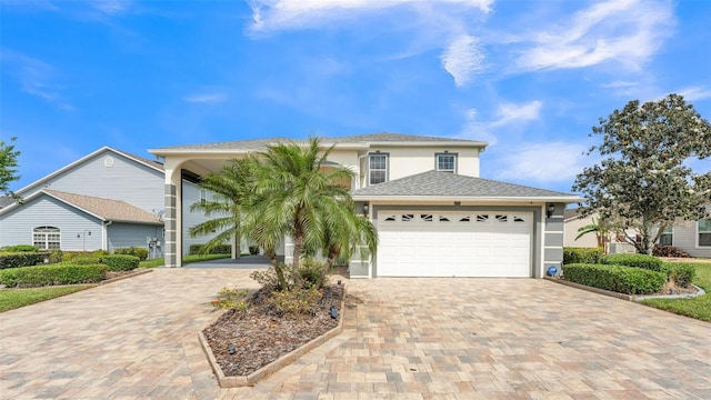 1062 Rally Dr, Polk City, FL 33868 - view of front of property with driveway, stucco siding, and a garage