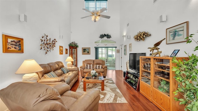 1062 Rally Dr, Polk City, FL 33868 - living room with a towering ceiling, ceiling fan, and wood finished floors