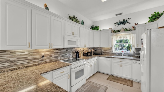 1062 Rally Dr, Polk City, FL 33868 - kitchen featuring visible vents, white cabinets, a sink, white appliances, and backsplash
