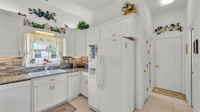 1062 Rally Dr, Polk City, FL 33868 - kitchen featuring a sink, light tile patterned floors, white cabinetry, and white appliances
