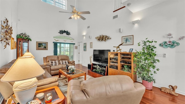 1062 Rally Dr, Polk City, FL 33868 - living room featuring visible vents, baseboards, a high ceiling, ceiling fan, and wood finished floors