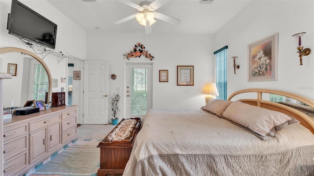 1062 Rally Dr, Polk City, FL 33868 - bedroom featuring visible vents, arched walkways, a ceiling fan, access to outside, and light colored carpet