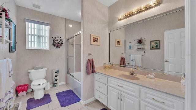 1062 Rally Dr, Polk City, FL 33868 - full bath featuring vanity, visible vents, toilet, enclosed tub / shower combo, and tile patterned floors