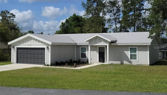 ranch-style house featuring a front yard, driveway, a shingled roof, and a garage