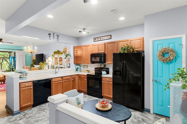 2125 Wild Grape Pl, Riverview, FL 33578 - kitchen featuring black appliances, a peninsula, backsplash, light countertops, and light marble finish flooring