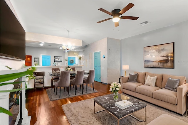 2125 Wild Grape Pl, Riverview, FL 33578 - living room with a ceiling fan, wood finished floors, and a chandelier