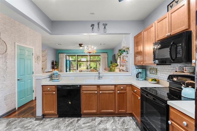 2125 Wild Grape Pl, Riverview, FL 33578 - kitchen featuring black appliances, a peninsula, light countertops, backsplash, and brown cabinetry