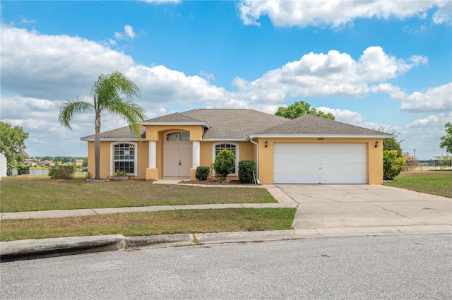 ranch-style home featuring concrete driveway, stucco siding, a front yard, a garage, and a shingled roof