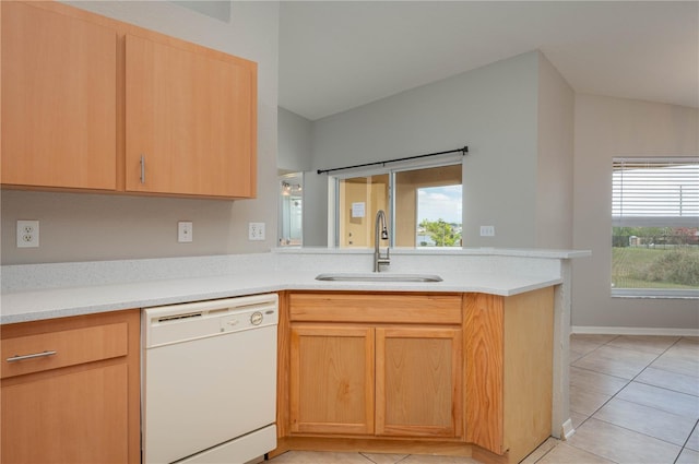 kitchen featuring a peninsula, dishwasher, light countertops, and a sink