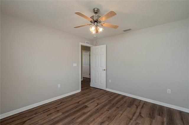 unfurnished room with visible vents, baseboards, a ceiling fan, and wood finished floors
