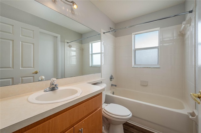 bathroom with toilet, vanity, shower / bathtub combination, and plenty of natural light