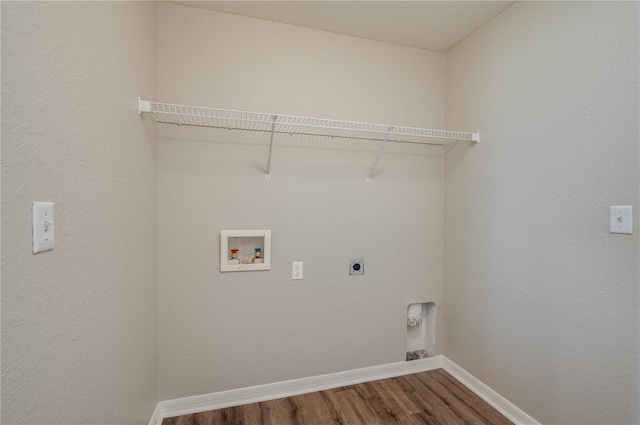 laundry room with laundry area, hookup for a washing machine, wood finished floors, hookup for an electric dryer, and baseboards